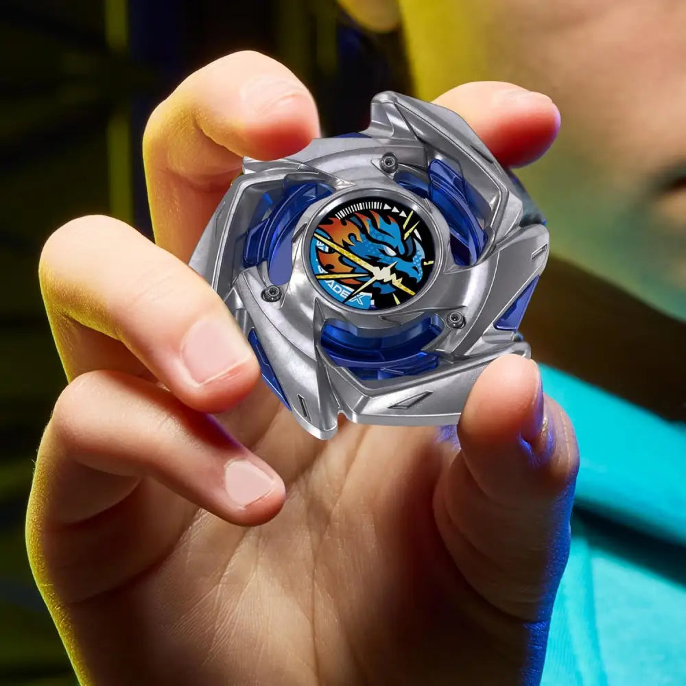 Silver and blue beyblade bx strike top with dragon design on face from strike dran starter set
