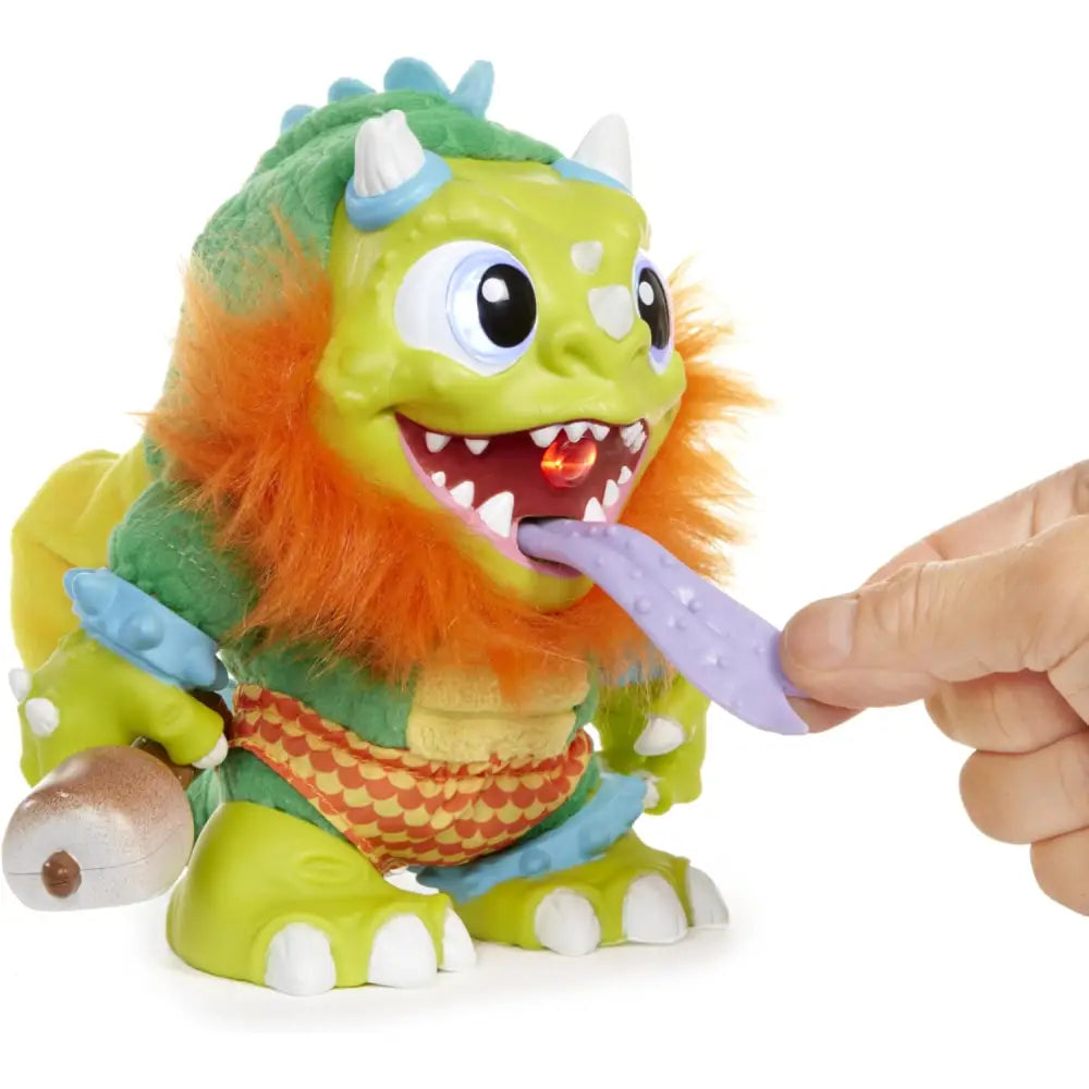 A crate creatures sizzle green furry monster toy with orange mane and blue horns featuring a glowing red tongue fed by hand