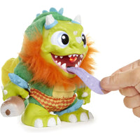 A crate creatures sizzle green furry monster toy with orange mane and blue horns featuring a glowing red tongue fed by hand