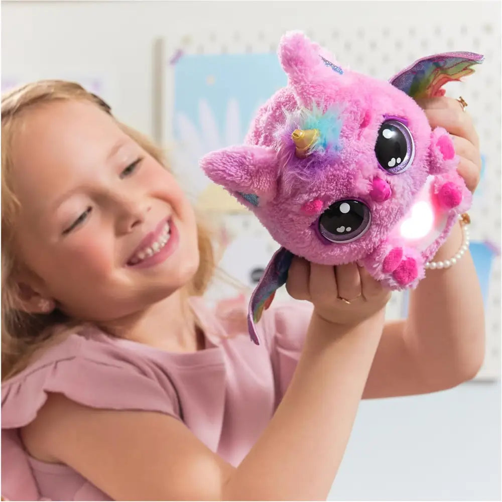 Pink plush unicorn toy with rainbow wings and glowing face from hatchimals alive uovo mystery hatch pufficorn collection