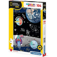 Scatola puzzle national geographic kids space explorer 104 pezzi con design spaziale terra razzi astronauti su sfondo nero