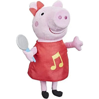 Peppa pig peluche originale hasbro rosa con vestito rosso e nota musicale gialla che canta tenendo uno specchio giocattolo grigio e blu