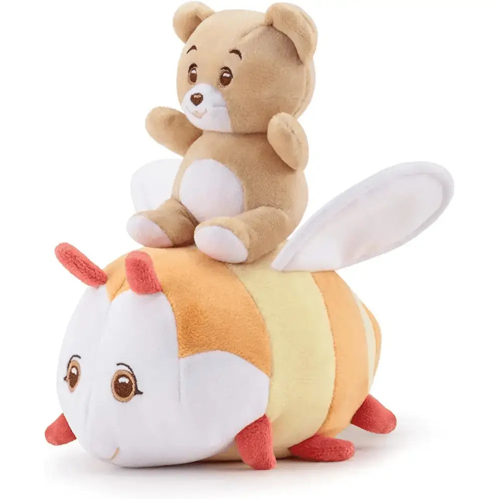 A teddy bear plush with tan fur and white accents sits on a soft striped bee toy in the trudi carillon ape dolce melodia