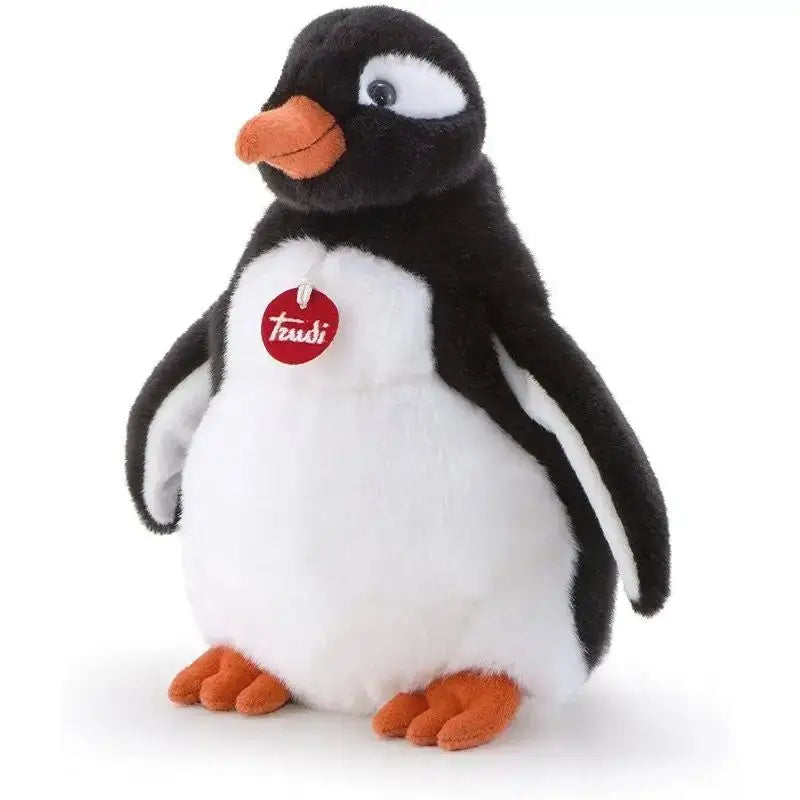 Un peluche trudi pinguino gina con pelliccia bianca e nera, becco e piedi arancioni e etichetta rossa taudi