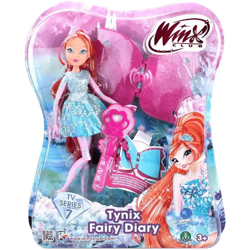 Winx tinyx fairy bloom doll in sparkling light blue dress with long orange hair and pink accessories in clear plastic packaging with diario segreto theme